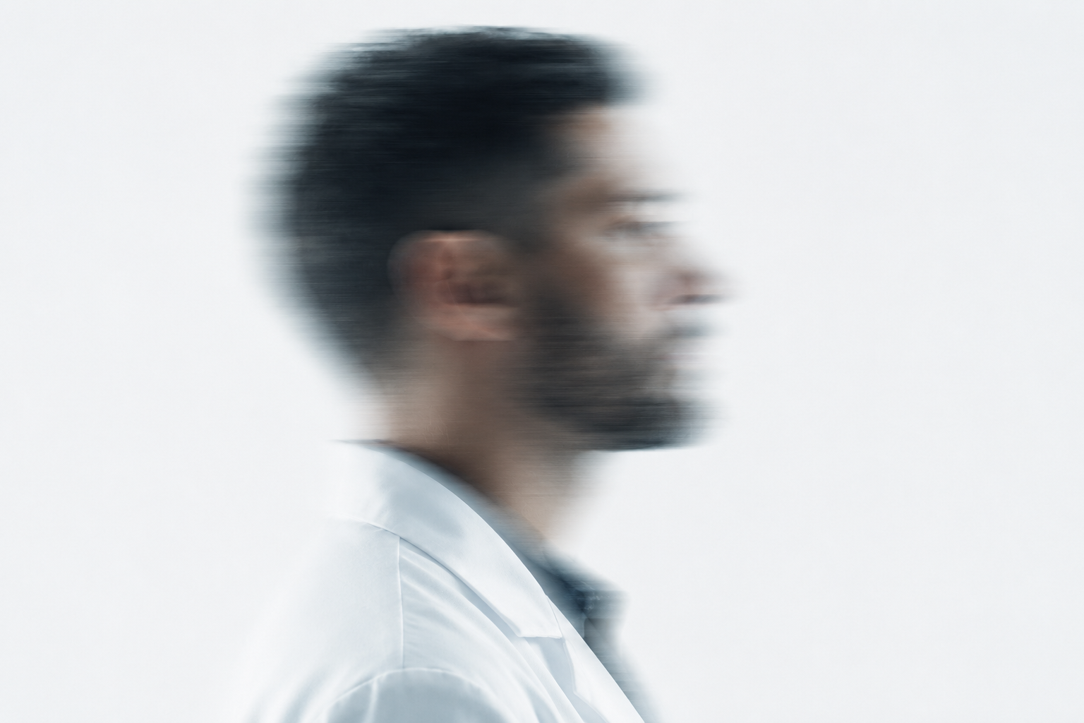Scientist in lab coat, motion blur portrait